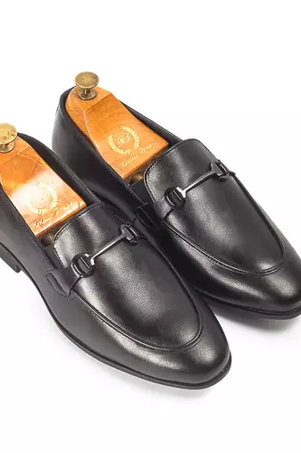 Black synthetic buckle slipons