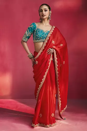 crimson red silk blend saree with teal blue embroidered blouse & zari border