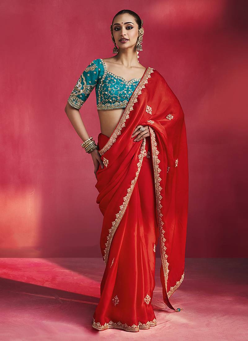 crimson red silk blend saree with teal blue embroidered blouse & zari border