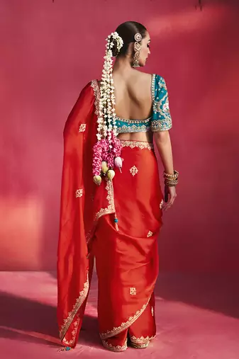 crimson red silk blend saree with teal blue embroidered blouse & zari border