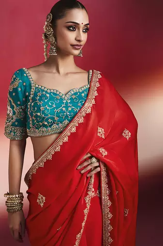 crimson red silk blend saree with teal blue embroidered blouse & zari border