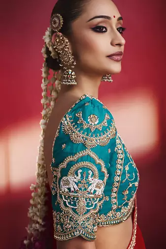 crimson red silk blend saree with teal blue embroidered blouse & zari border