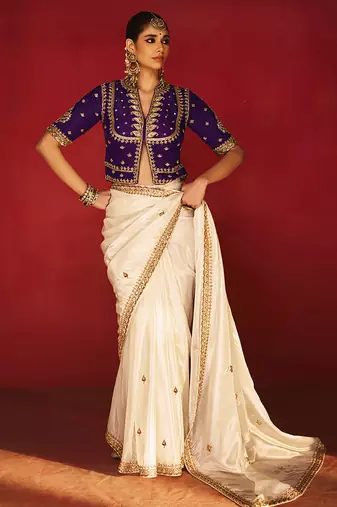 white silk blend saree with purple embroidered blouse & zari border