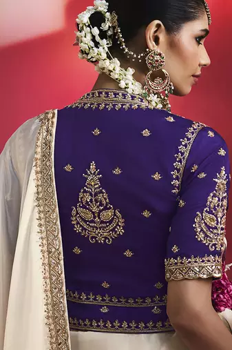 white silk blend saree with purple embroidered blouse & zari border