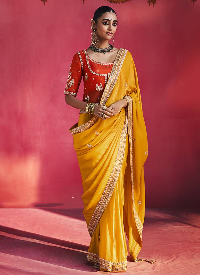 mustard yellow silk blend saree with red embroidered blouse & zari border