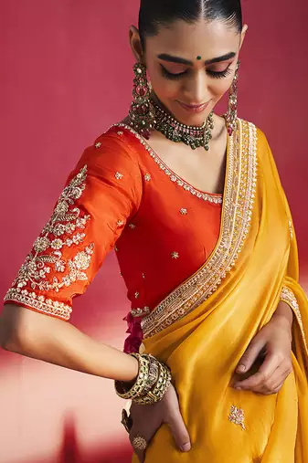 mustard yellow silk blend saree with red embroidered blouse & zari border