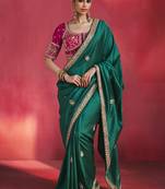 bottle green silk blend saree with rani pink embroidered blouse & zari border