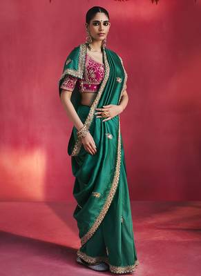 bottle green silk blend saree with rani pink embroidered blouse & zari border 2