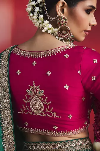bottle green silk blend saree with rani pink embroidered blouse & zari border