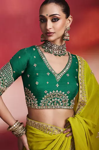 lime green silk blend saree with bottle green embroidered blouse & zari border
