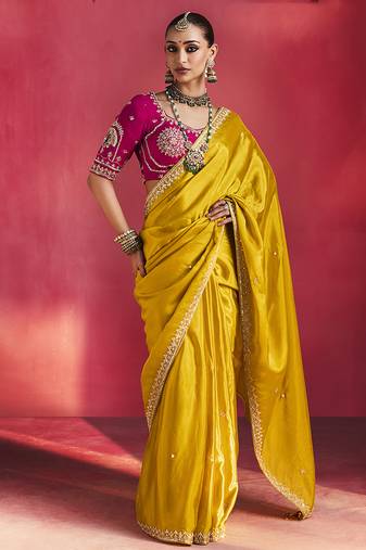 mustard yellow silk blend saree with rani pink embroidered blouse & zari border
