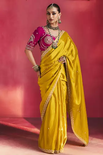 mustard yellow silk blend saree with rani pink embroidered blouse & zari border