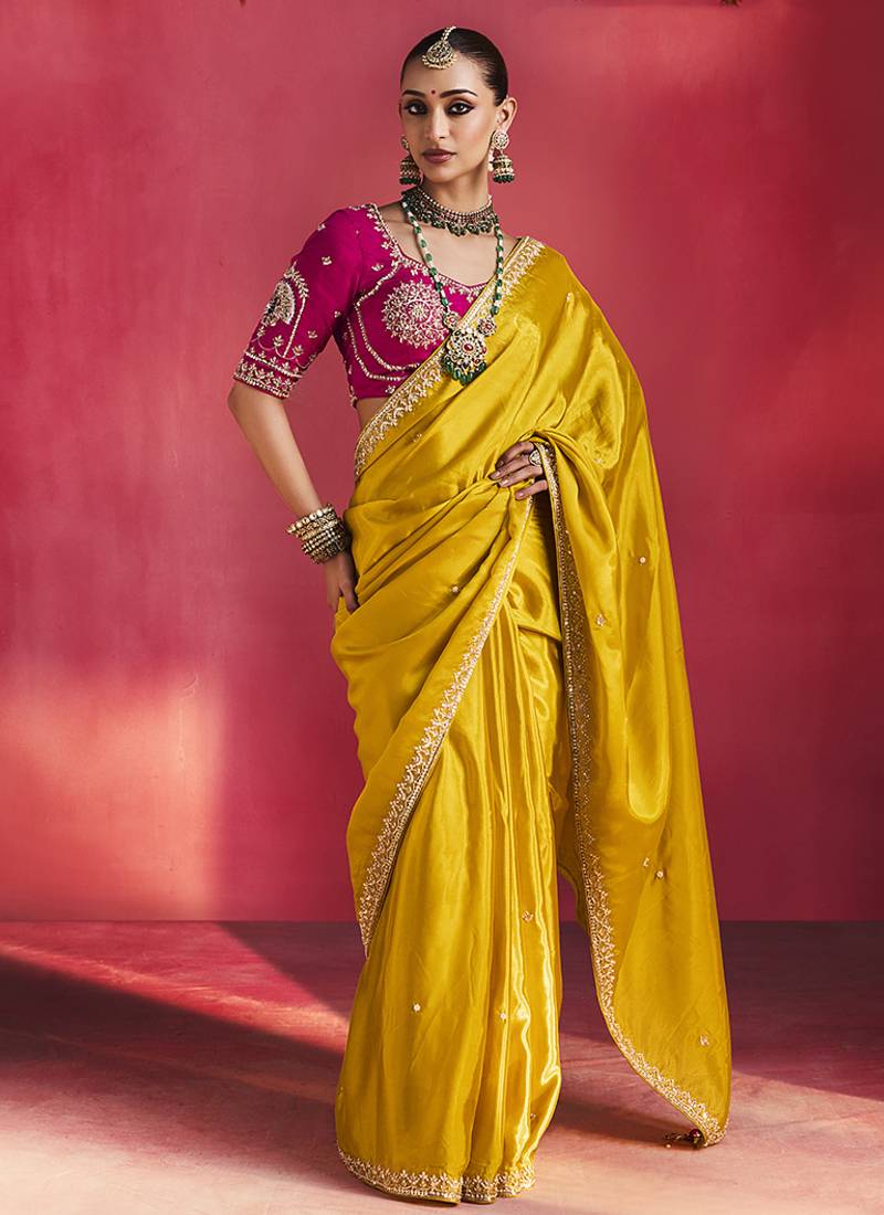 mustard yellow silk blend saree with rani pink embroidered blouse & zari border