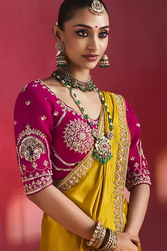 mustard yellow silk blend saree with rani pink embroidered blouse & zari border