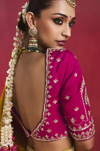 mustard yellow silk blend saree with rani pink embroidered blouse & zari border