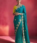 teal blue silk blend saree with yellow embroidered blouse & zari border