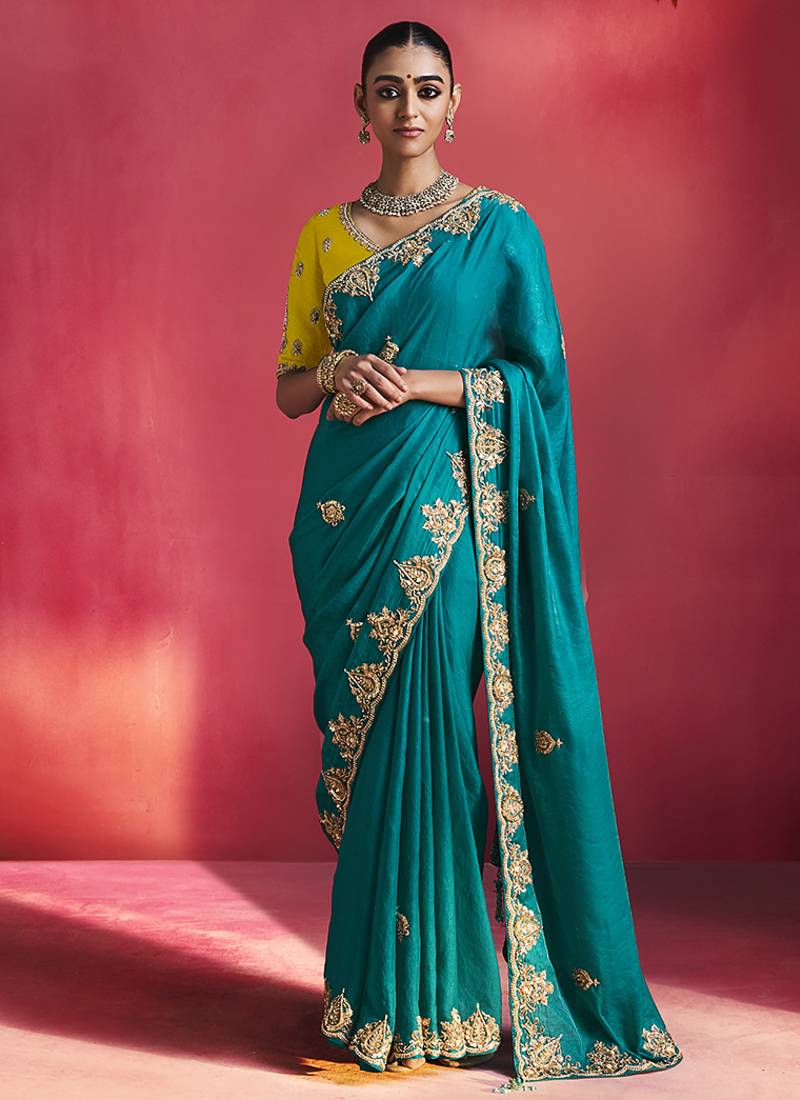 teal blue silk blend saree with yellow embroidered blouse & zari border