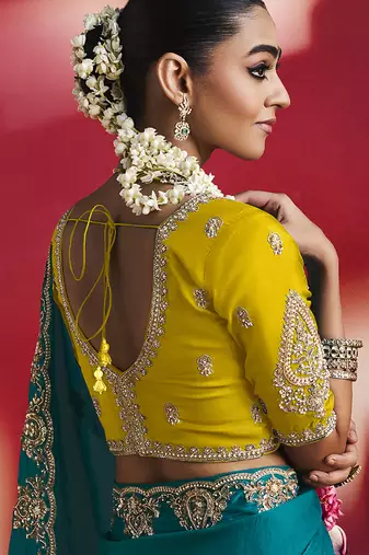 teal blue silk blend saree with yellow embroidered blouse & zari border