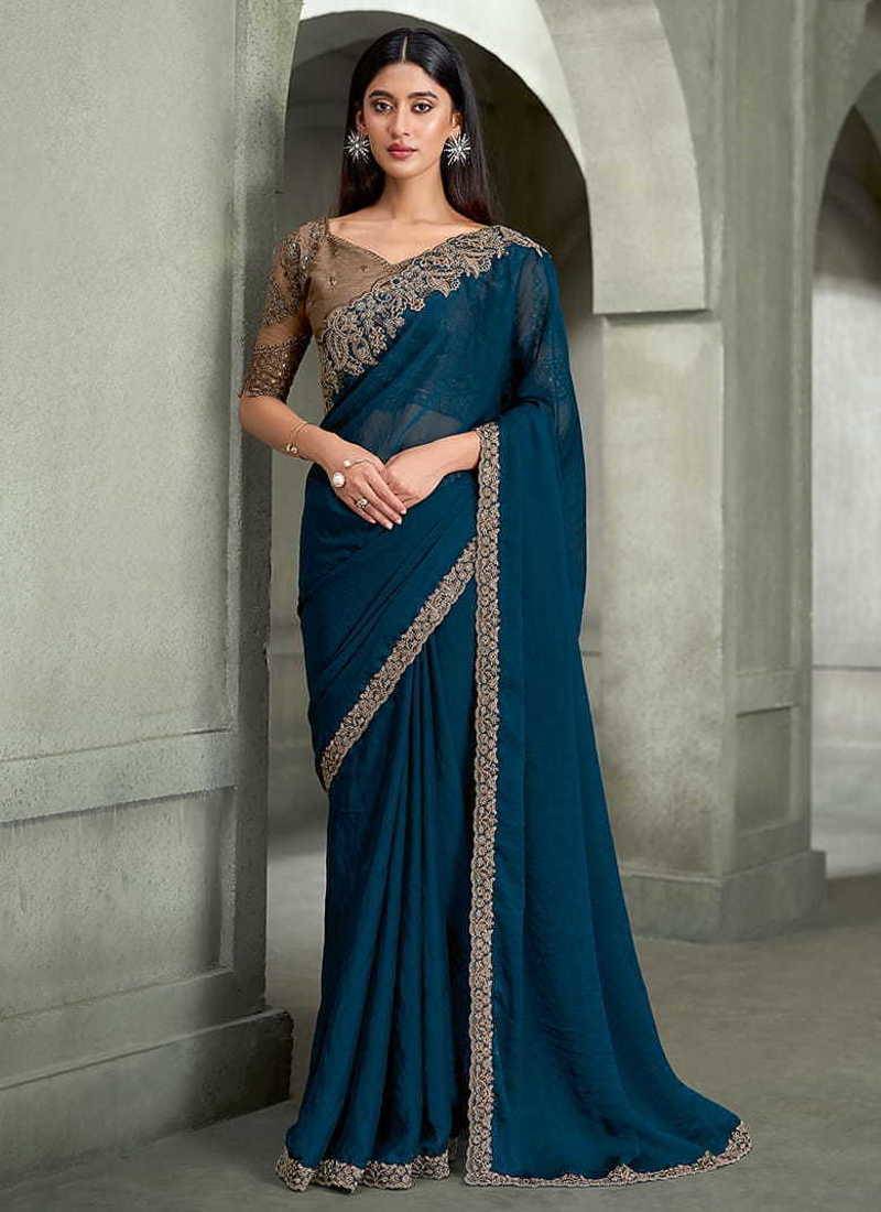 teal blue faux georgette saree with antique gold embroidered border
