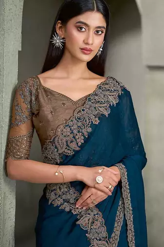teal blue faux georgette saree with antique gold embroidered border