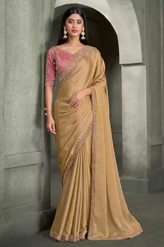 beige gold faux georgette saree with onion pink embroidered blouse