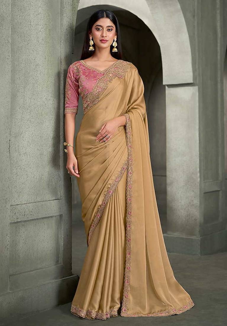 beige gold faux georgette saree with onion pink embroidered blouse
