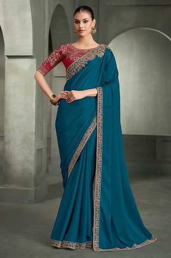 teal blue faux crepe saree with crimson red embroidered blouse