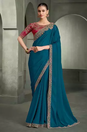 teal blue faux crepe saree with crimson red embroidered blouse