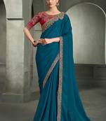teal blue faux crepe saree with crimson red embroidered blouse