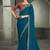 teal blue faux crepe saree with crimson red embroidered blouse