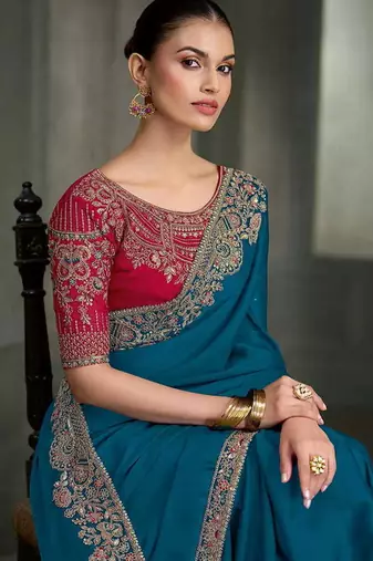 teal blue faux crepe saree with crimson red embroidered blouse