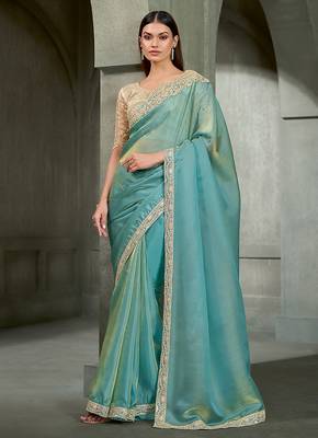 sea green shimmer faux tissue saree with cream embroidered blouse 1