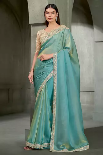 sea green shimmer faux tissue saree with cream embroidered blouse