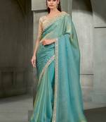 sea green shimmer faux tissue saree with cream embroidered blouse