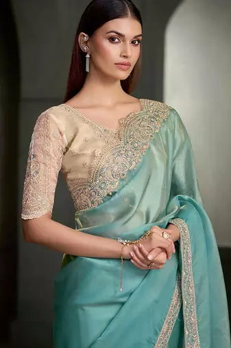 sea green shimmer faux tissue saree with cream embroidered blouse