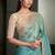 sea green shimmer faux tissue saree with cream embroidered blouse