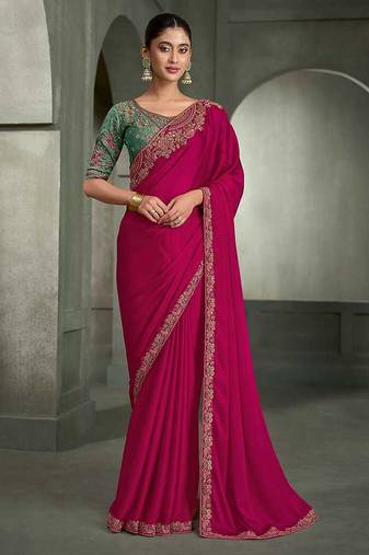 rani pink faux chiffon saree with green embroidered blouse