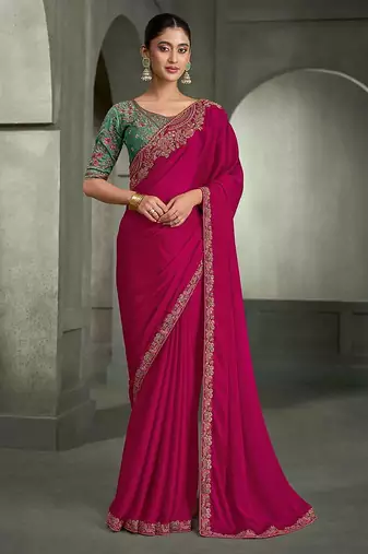 rani pink faux chiffon saree with green embroidered blouse