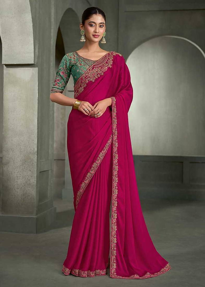 rani pink faux chiffon saree with green embroidered blouse