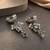 German silver bird motif clear long dome jhumka earrings