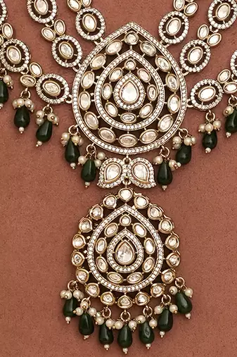 Royal polki kundan green stone layered necklace set with maang tikka