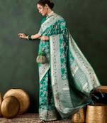 Green silk blend woven saree with zari work