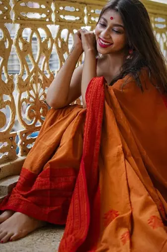 Yellow orange linen jacuard work festival saree with unstitched blouse piece