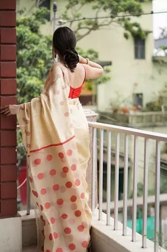 Cream red linen jacuard work festival saree with unstitched blouse piece