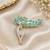 Elegant swan bird brooch with blue crystal leaf design & rhinestone detailing