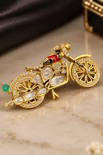 Elegant bicycle brooch with green crystal, clear stones & red enamel detailing