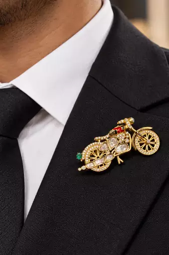 Elegant bicycle brooch with green crystal, clear stones & red enamel detailing