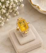 Elegant golden yellow gemstone statement ring with clear stone border