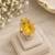 Elegant golden yellow gemstone statement ring with clear stone border