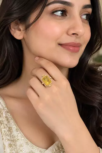 Elegant golden yellow gemstone statement ring with clear stone border